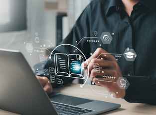 Hands at a laptop with a stylus and stylized technology icons