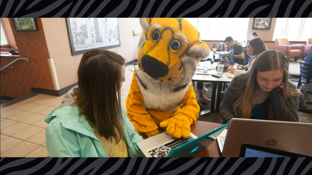Truman at a laptop with students